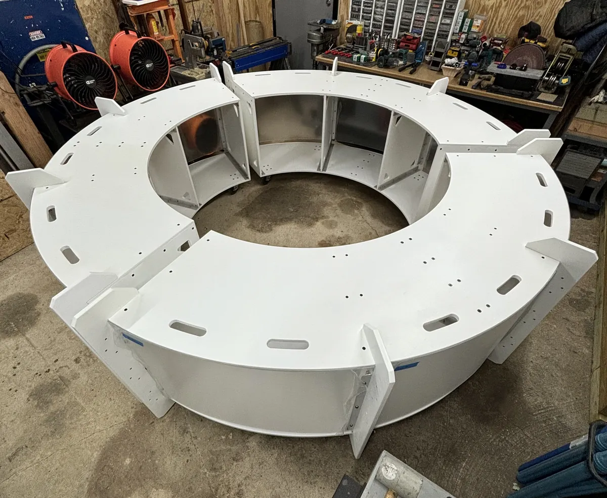 The white 10 ft round, 360° DJ booth assembled in the workshop, seen from above