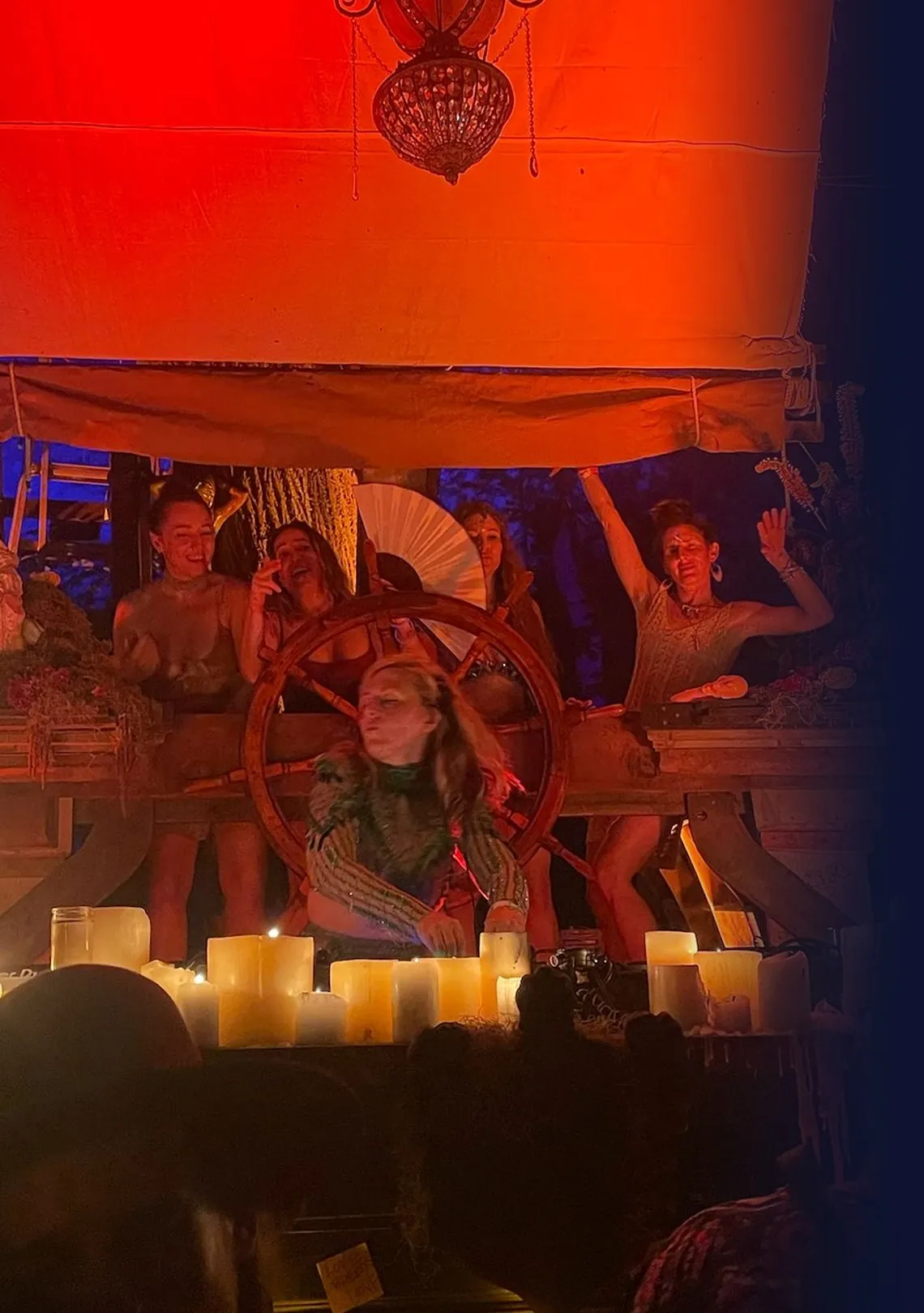 Daniela DJing on the candlelit ship stage at CAMP Festival 2025, dancers behind her