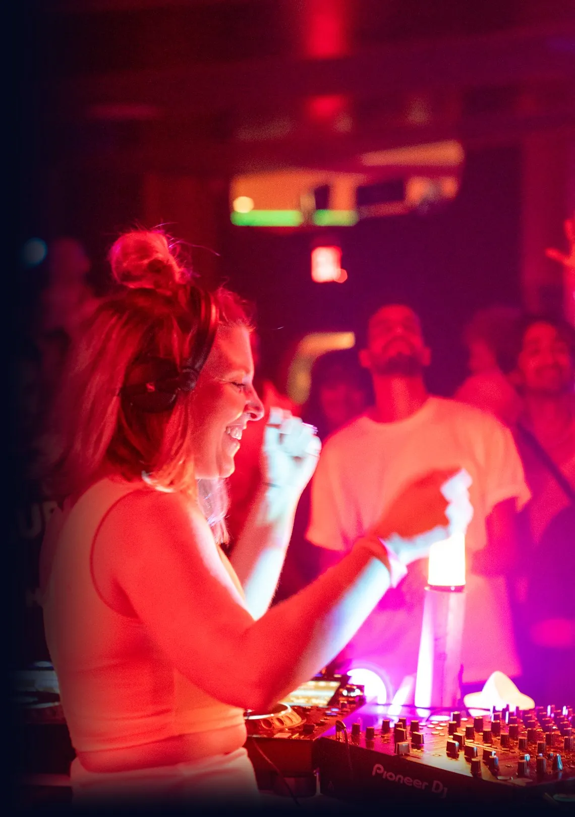 Daniela smiling and dancing at the decks at Xanadu, Brooklyn