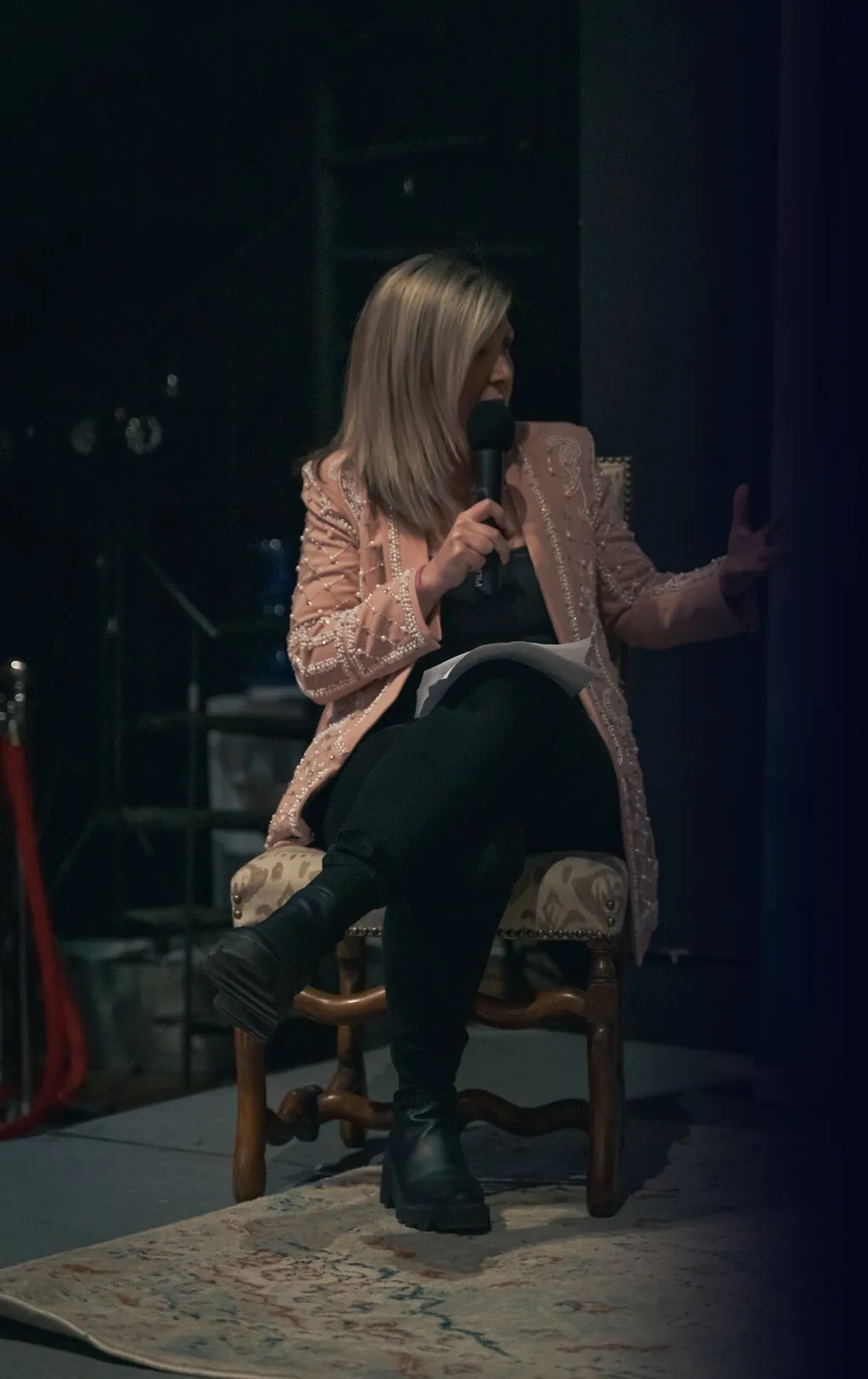 Daniela speaking on a panel, microphone in hand