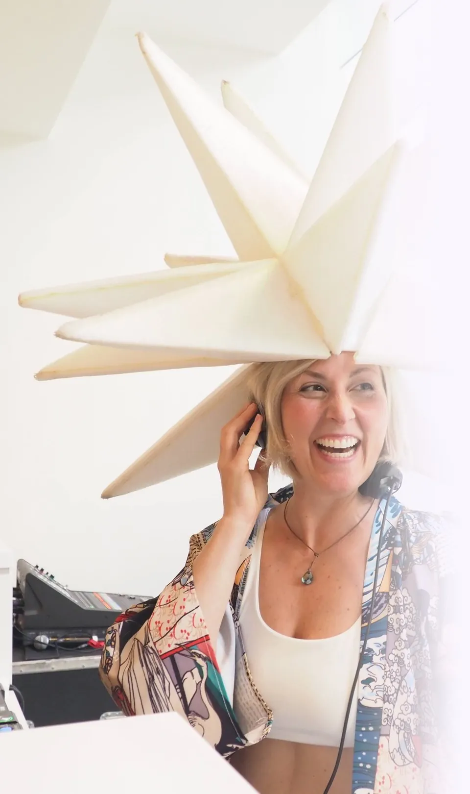 Daniela laughing at the decks in a giant white star headpiece